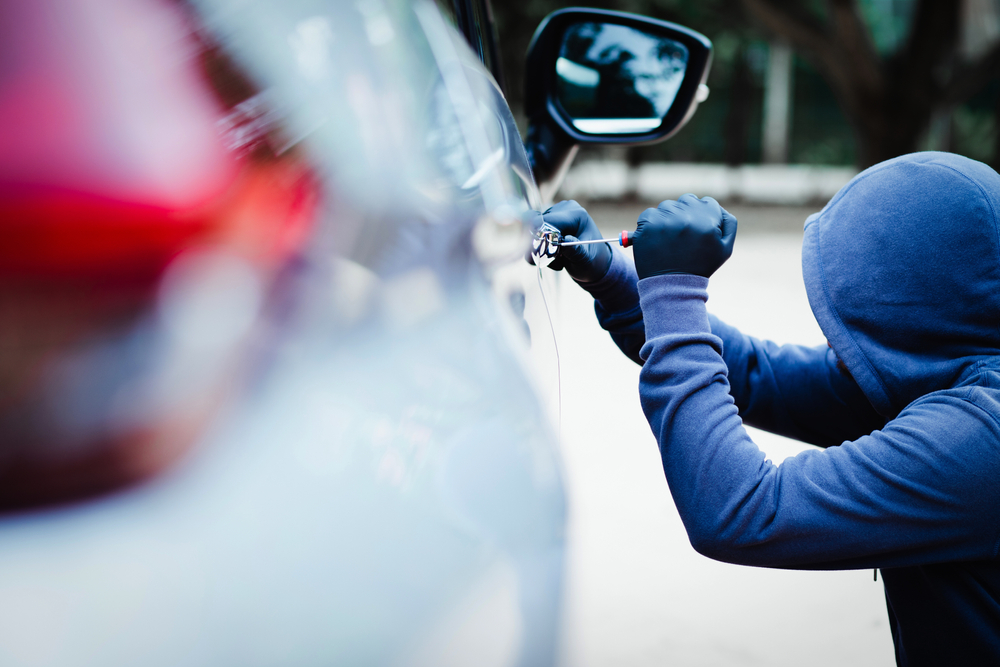 Male,trying,tool,to,break,into,a,car.